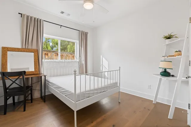 a view of a bedroom with furniture and windows