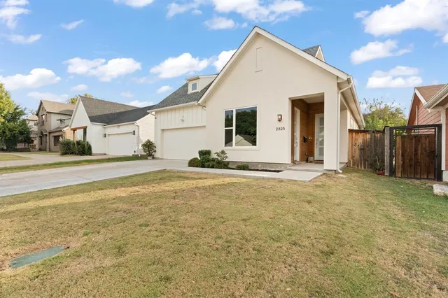 a view of a white house with a yard