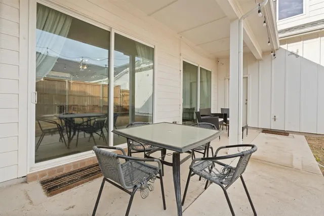 a view of a dining room with furniture a chandelier and wooden floor