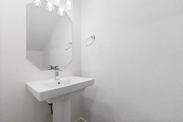a bathroom with a sink a mirror and vanity