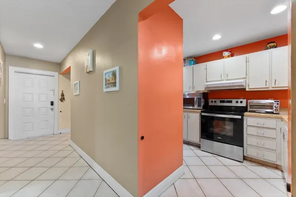 a kitchen with stainless steel appliances a stove a microwave and a refrigerator