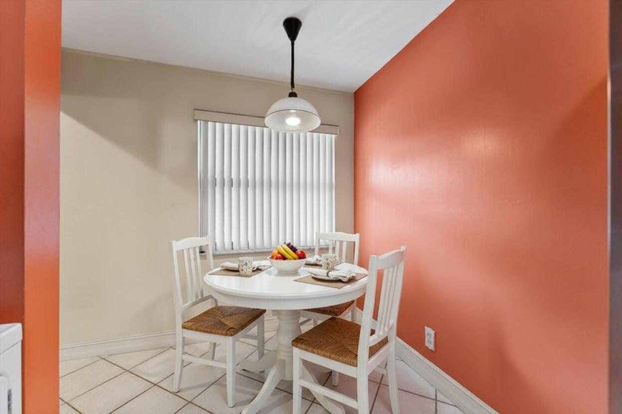 3122 Southwest 20th Terrace, Unit 25B2 Delray Beach, FL 33445 - Photo 14 of 32 a view of a dining room with furniture and wooden floor
