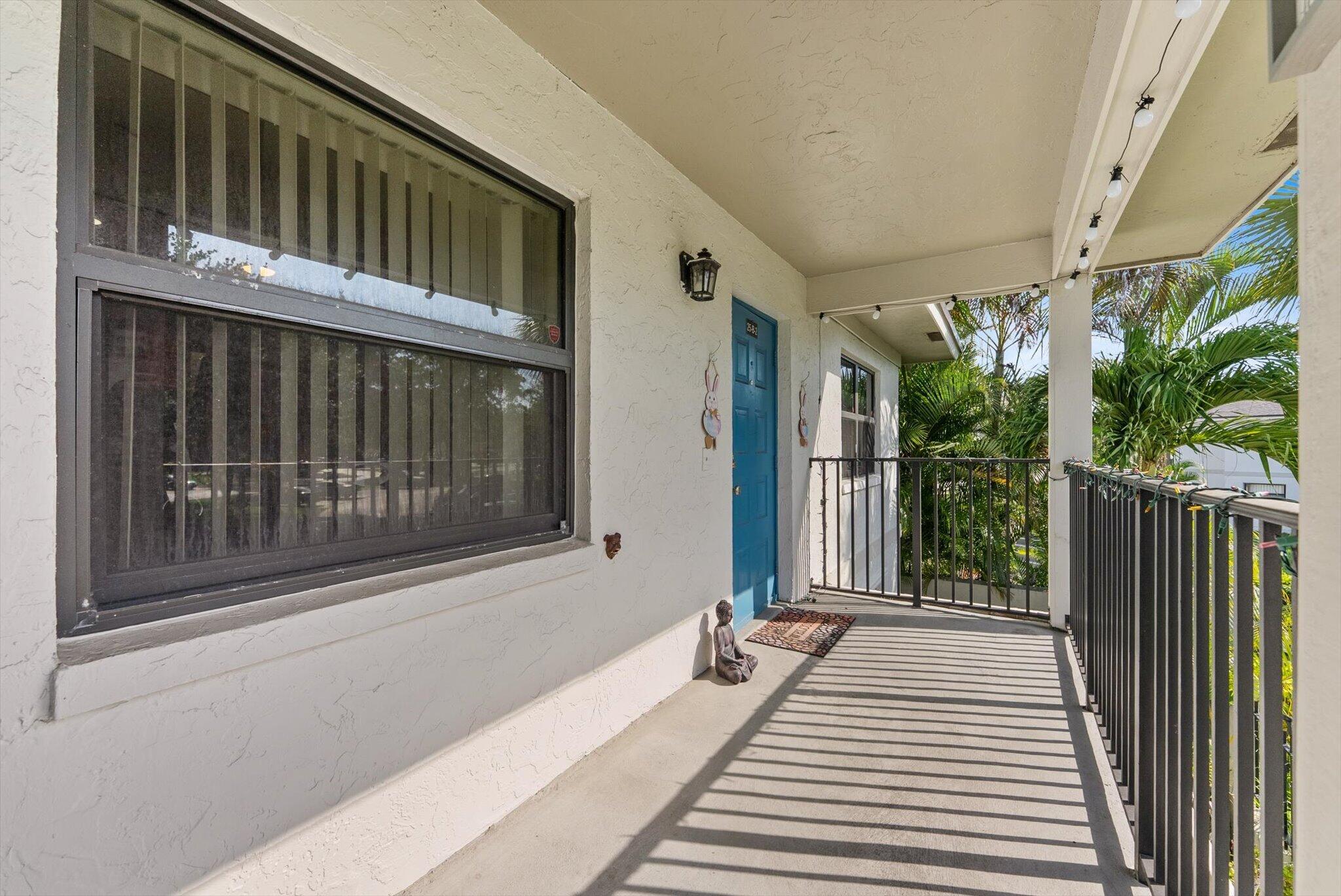 3122 Southwest 20th Terrace, Unit 25B2 Delray Beach, FL 33445 - Photo 17 of 32 a balcony view with a garden space