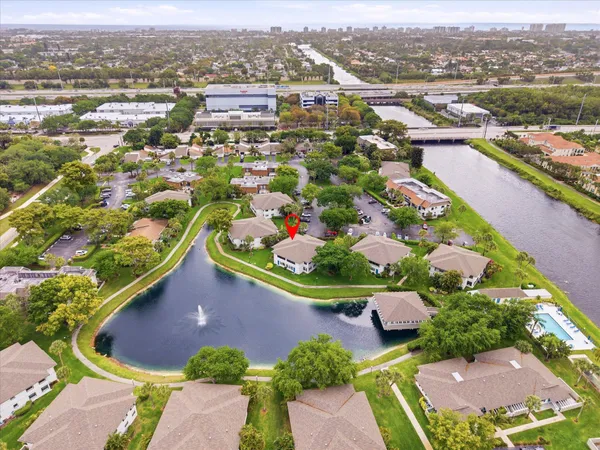 an aerial view of residential houses with outdoor space and river