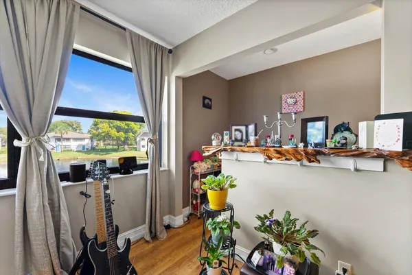 a view of living room with furniture and a potted plant