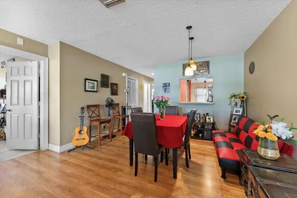 a view of a dining room with furniture window and wooden floor
