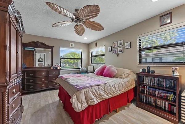 a bedroom with a bed and a book shelf