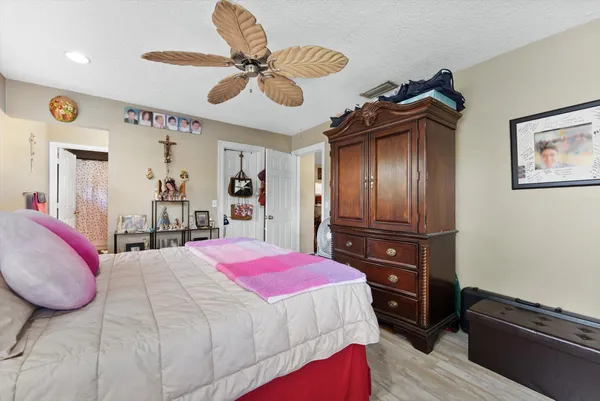 a bedroom with a bed and a chandelier