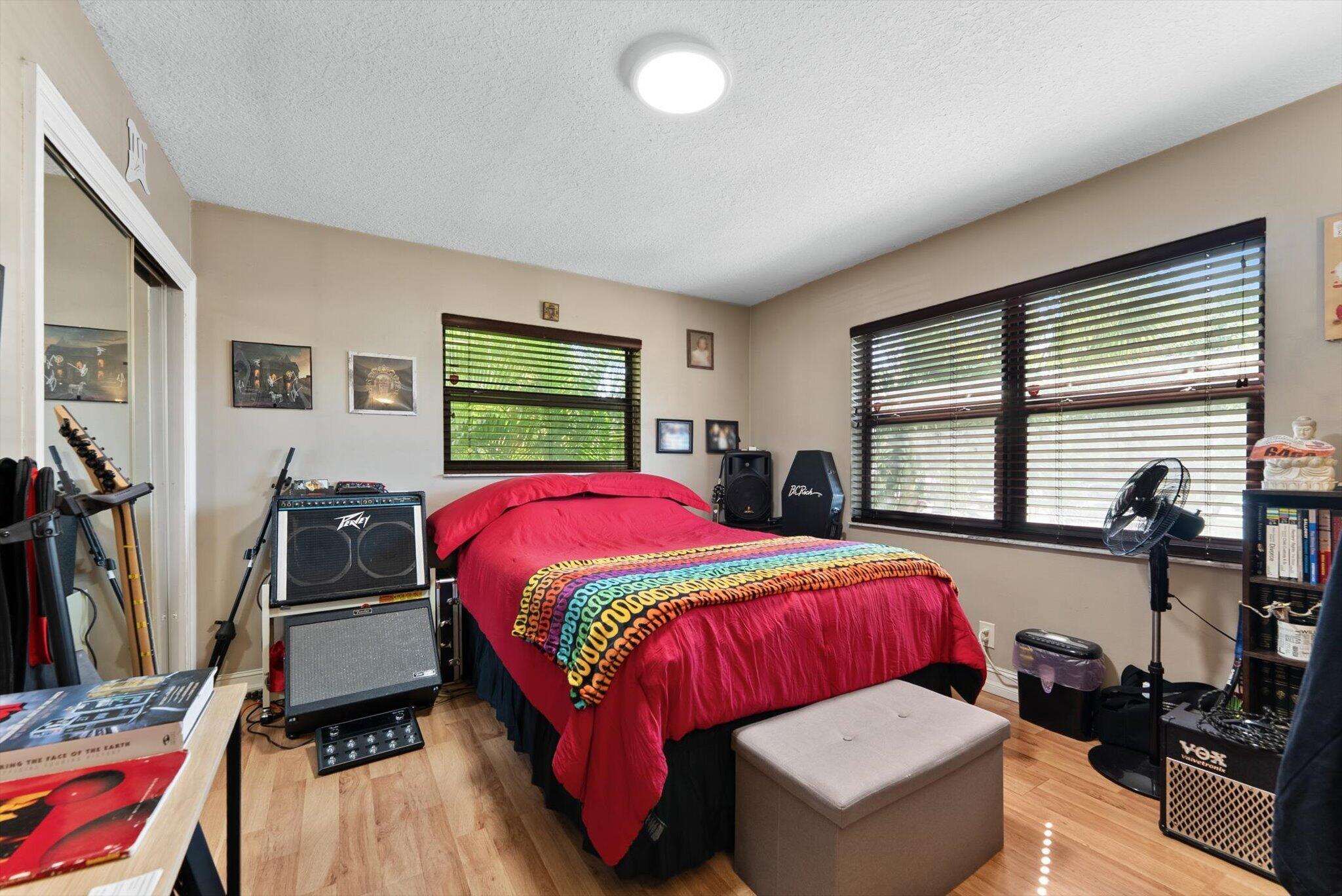 3122 Southwest 20th Terrace, Unit 25B2 Delray Beach, FL 33445 - Photo 10 of 32 a bedroom with a bed and a table
