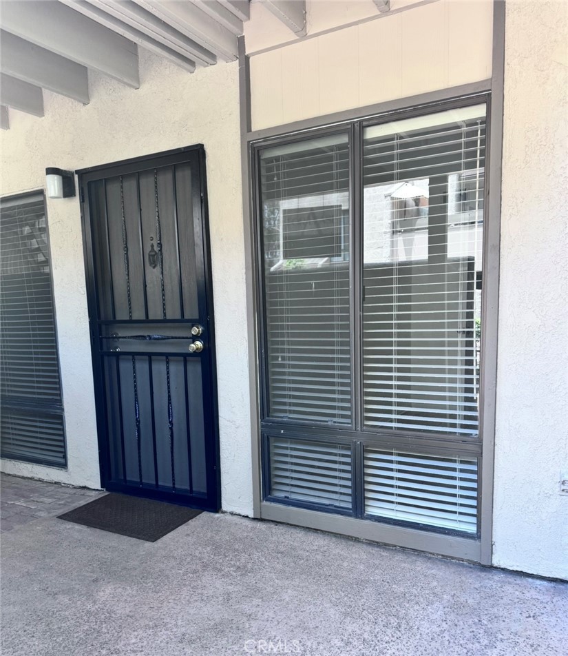 3032 Associated Road, Unit 76 Fullerton, CA 92835 - Photo 2 of 14 a view of backyard with wooden door