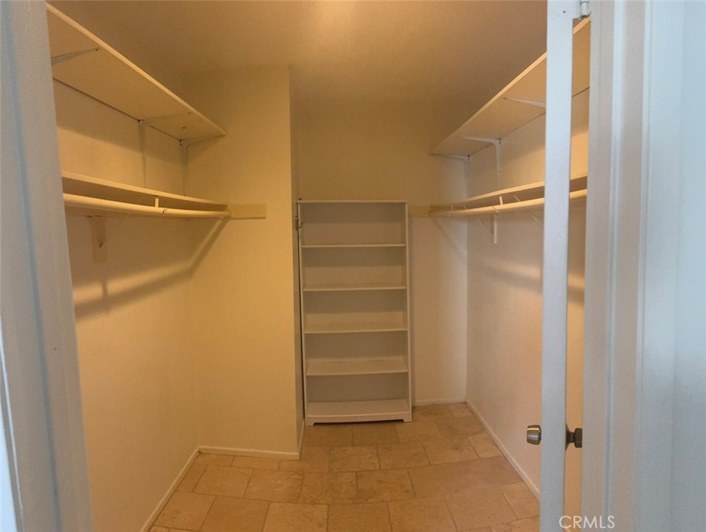 3032 Associated Road, Unit 76 Fullerton, CA 92835 - Photo 6 of 14 a view of walk in closet with empty racks