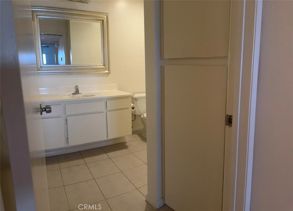 3032 Associated Road, Unit 76 Fullerton, CA 92835 - Photo 7 of 14 a bathroom with a sink vanity and mirror