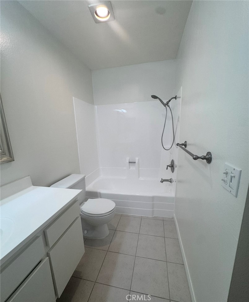 3032 Associated Road, Unit 76 Fullerton, CA 92835 - Photo 8 of 14 a bathroom with a sink a toilet and shower