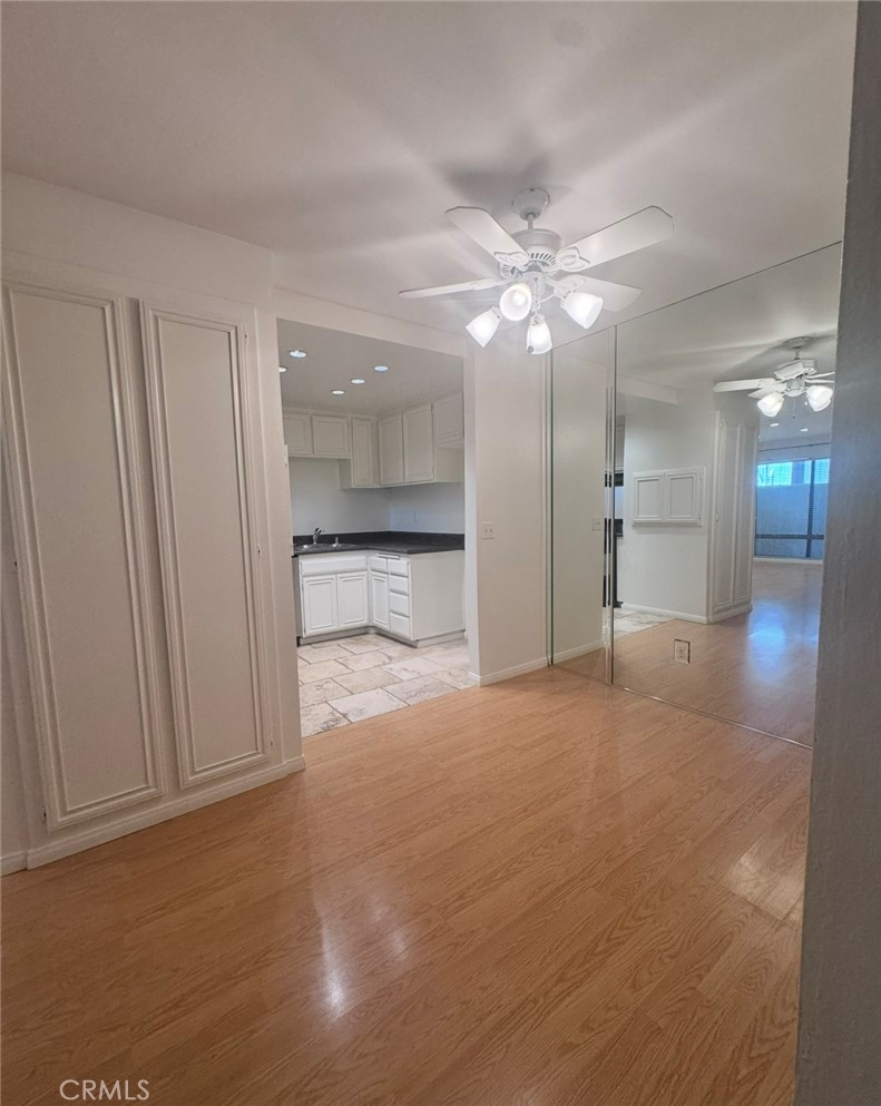 3032 Associated Road, Unit 76 Fullerton, CA 92835 - Photo 10 of 14 a view of a hallway with a chandelier fan