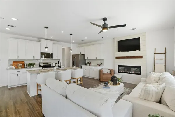 a living room with furniture a fireplace and a flat screen tv