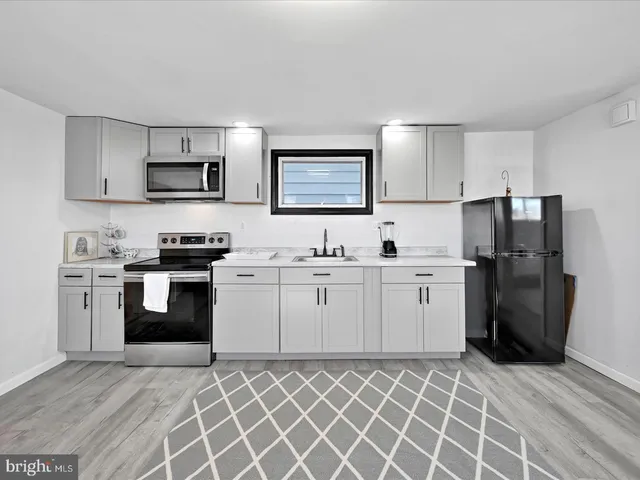 a kitchen with cabinets and stainless steel appliances