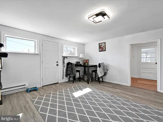 a view of a livingroom with workspace and a window