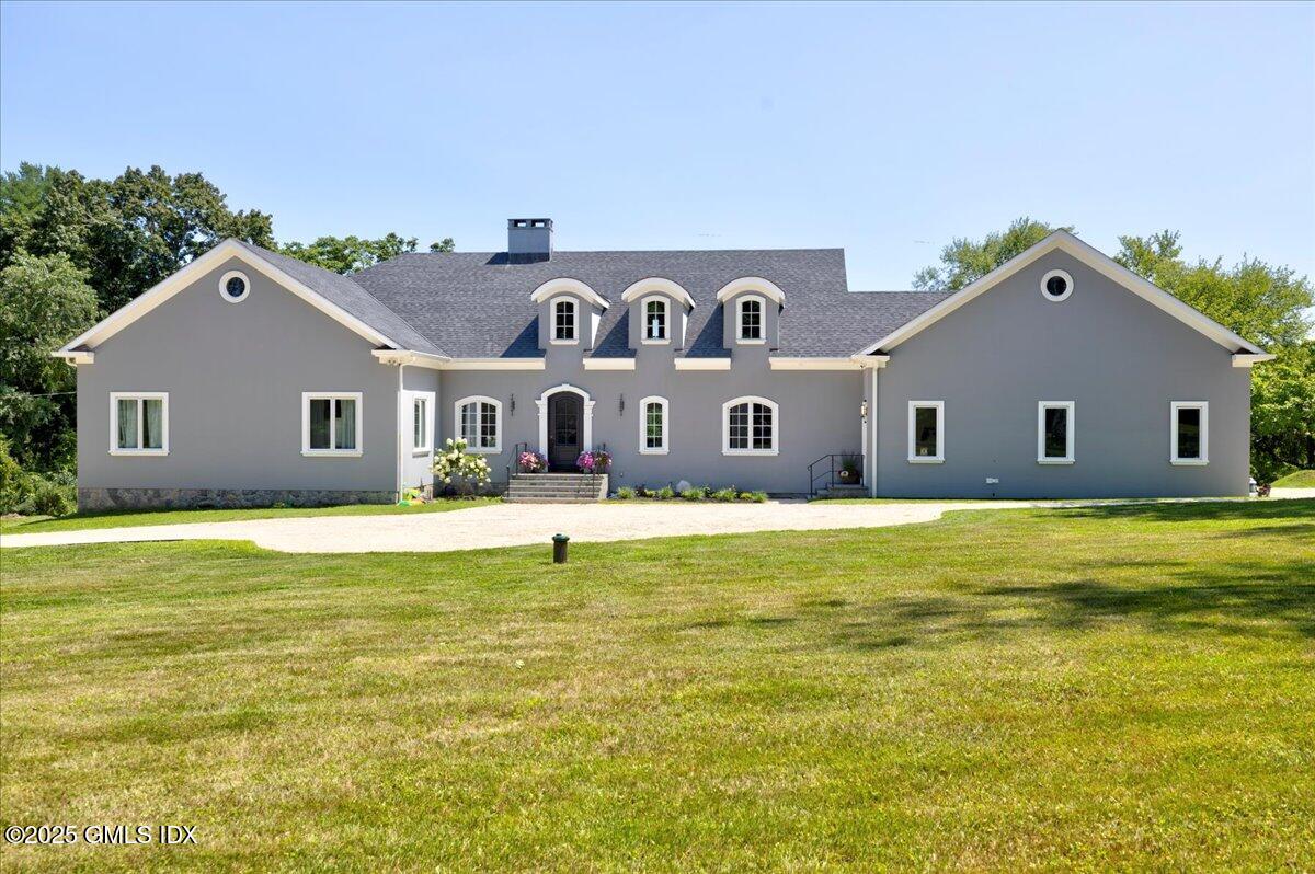 a house with swimming pool in front of it