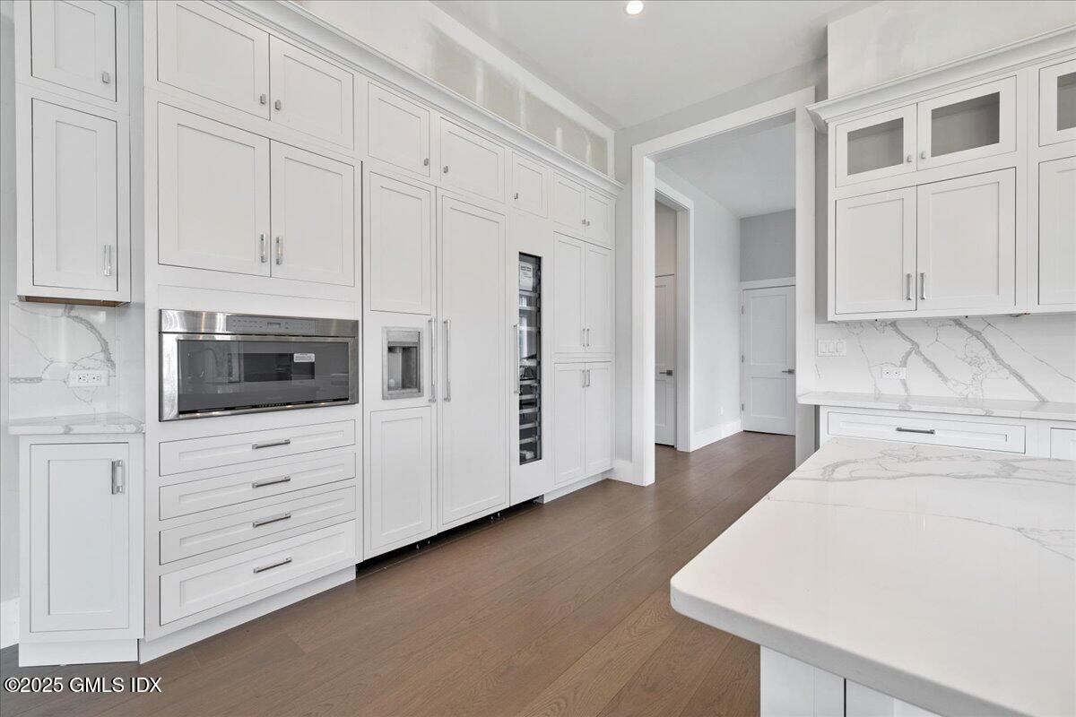 424 Taconic Road Greenwich, CT 06831 - Photo 11 of 35 a kitchen with white cabinets and white appliances
