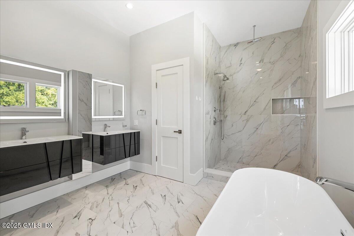 424 Taconic Road Greenwich, CT 06831 - Photo 15 of 35 a bathroom with a tub sink shower and two mirror