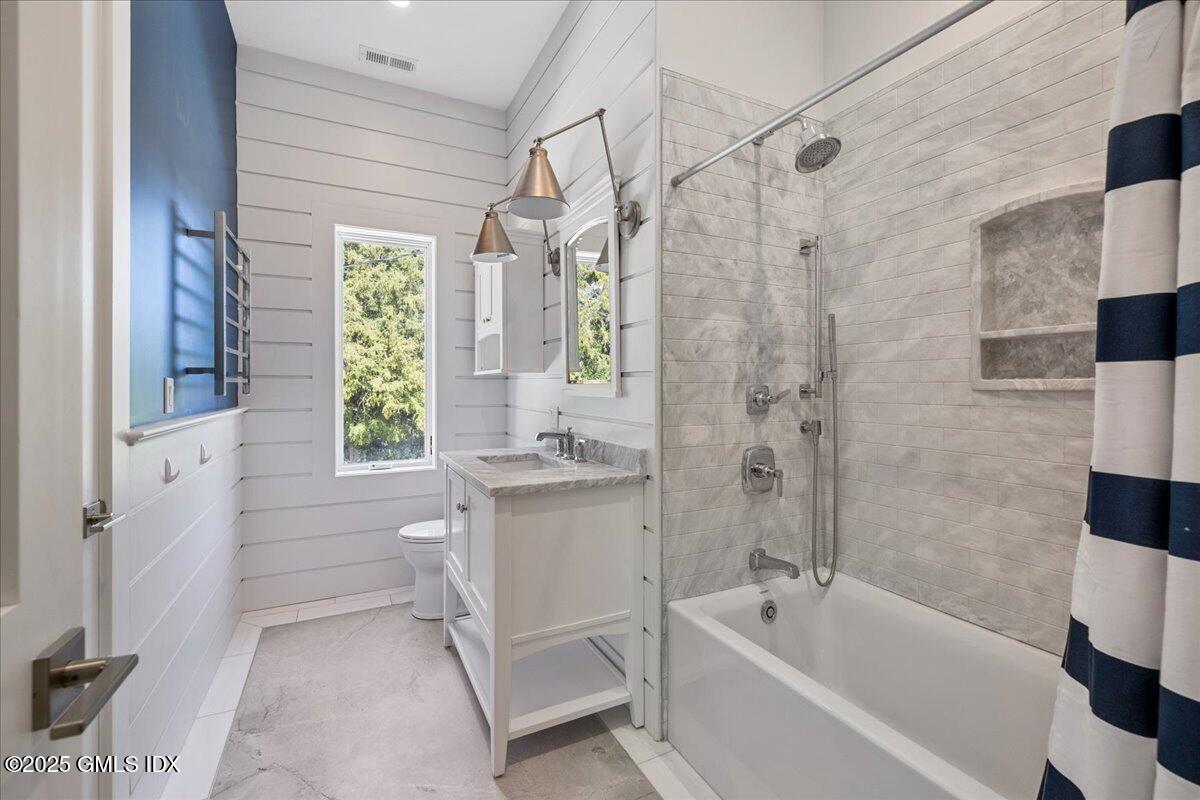 424 Taconic Road Greenwich, CT 06831 - Photo 20 of 35 a bathroom with a bathtub a window and a shower