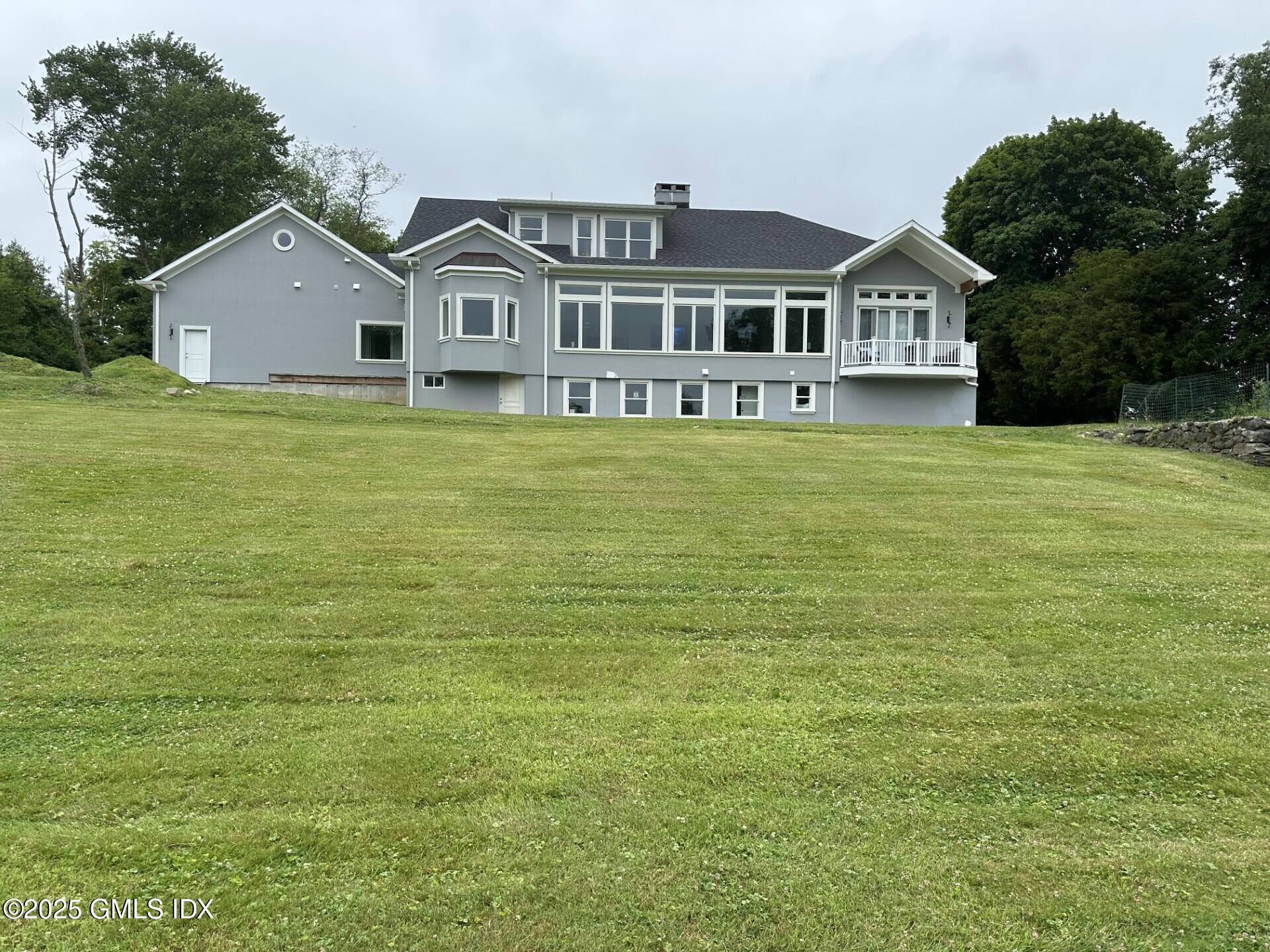 424 Taconic Road Greenwich, CT 06831 - Photo 30 of 35 a front view of a house with a garden
