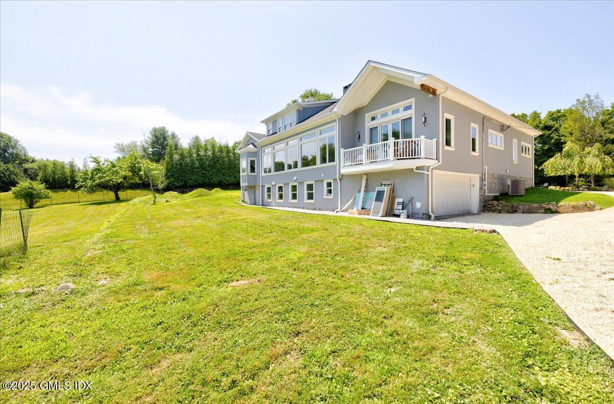 424 Taconic Road Greenwich, CT 06831 - Photo 32 of 35 a large pool with lawn chairs and large trees