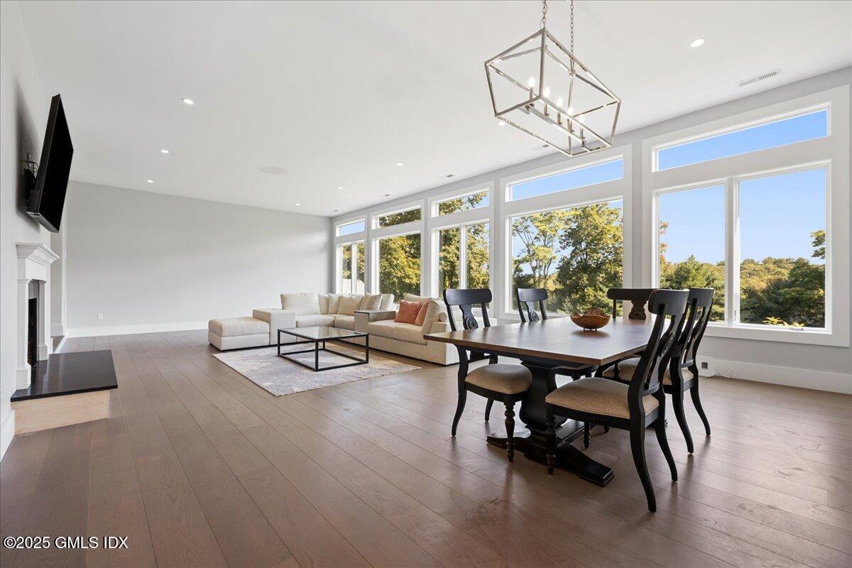 424 Taconic Road Greenwich, CT 06831 - Photo 5 of 35 a dining room with furniture a chandelier and wooden floor