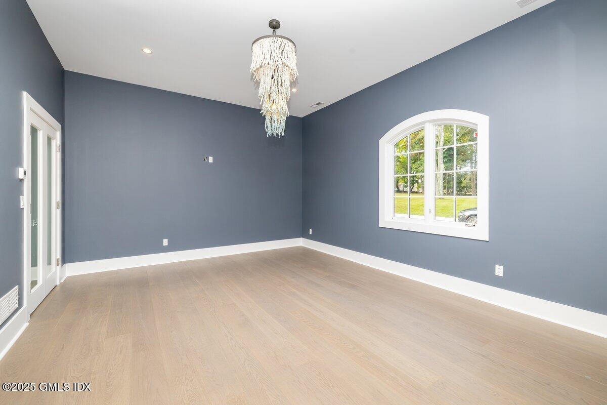 424 Taconic Road Greenwich, CT 06831 - Photo 7 of 35 an empty room with a chandelier