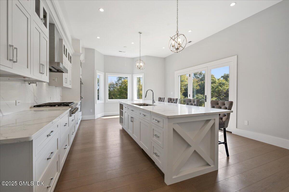 424 Taconic Road Greenwich, CT 06831 - Photo 9 of 35 a large kitchen with granite countertop a large island in the center