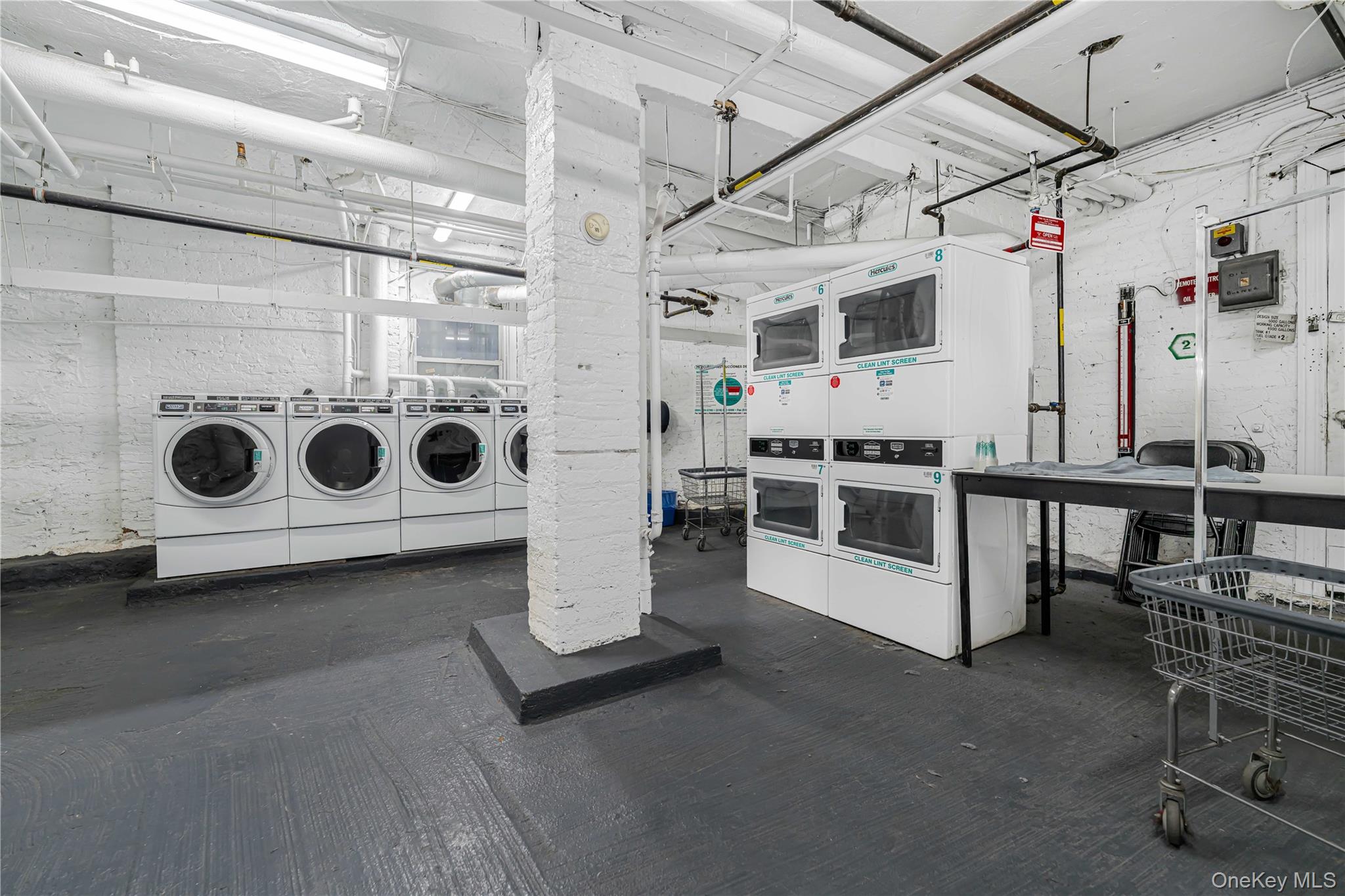 880 West 181st Street, Unit 6G Manhattan, NY 10033 - Photo 11 of 13 a utility room with multiple dryer and washer