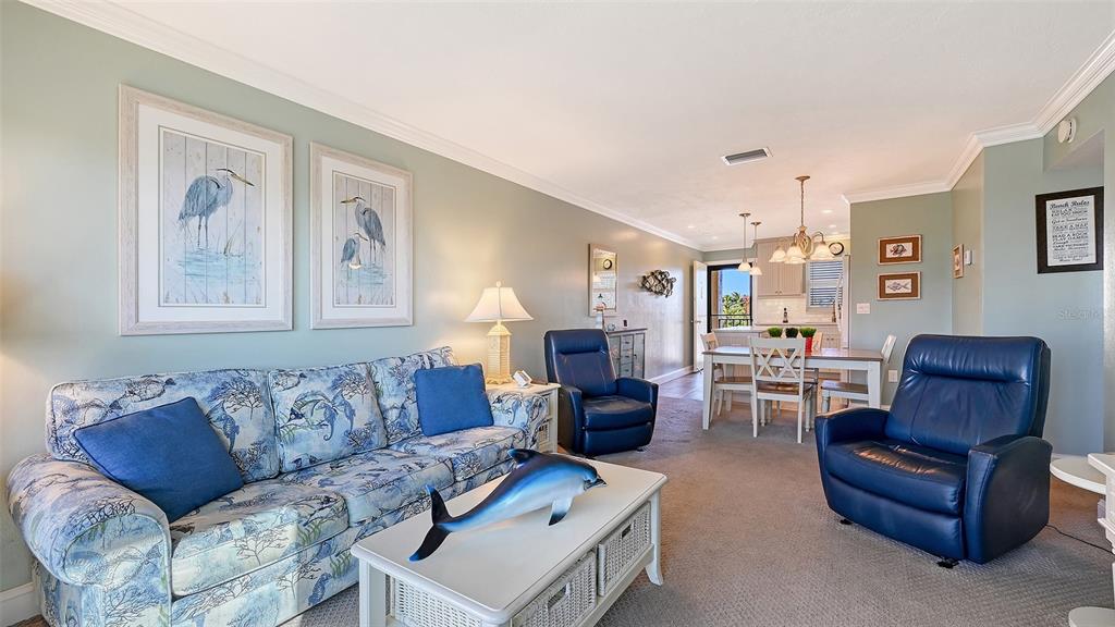 925 Beach Road, Unit 311 Sarasota, FL 34242 - Photo 11 of 53 a living room with furniture couches and a potted plant on dresser