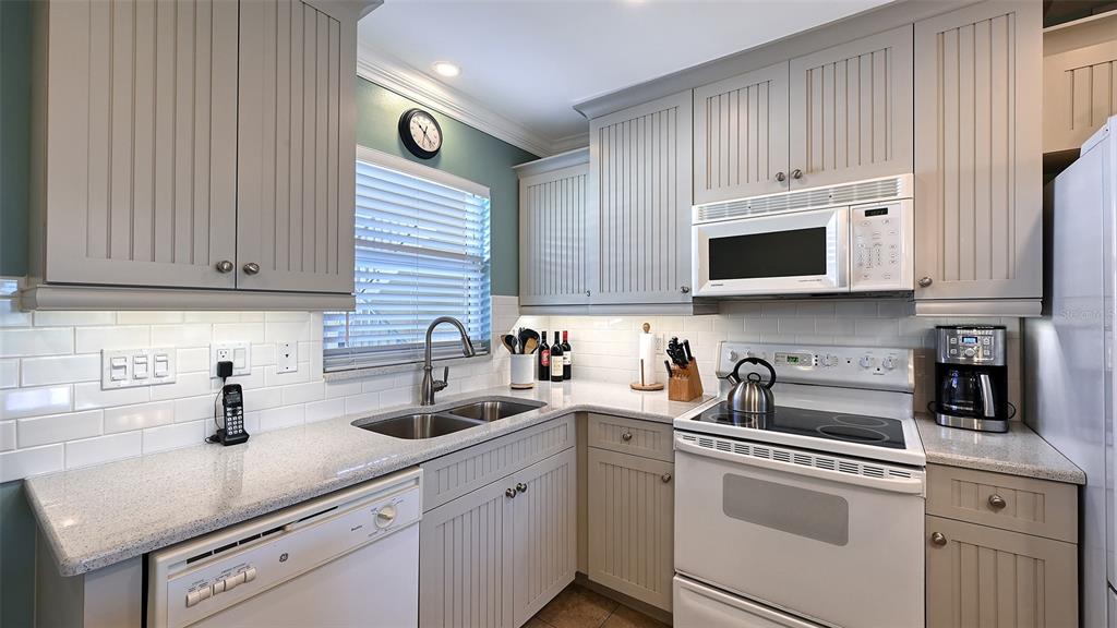 925 Beach Road, Unit 311 Sarasota, FL 34242 - Photo 14 of 53 a kitchen with appliances a sink and cabinets