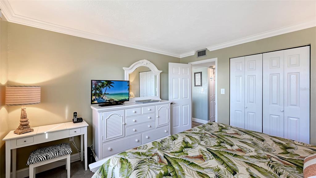 925 Beach Road, Unit 311 Sarasota, FL 34242 - Photo 17 of 53 a bedroom with a bed and a flat screen tv
