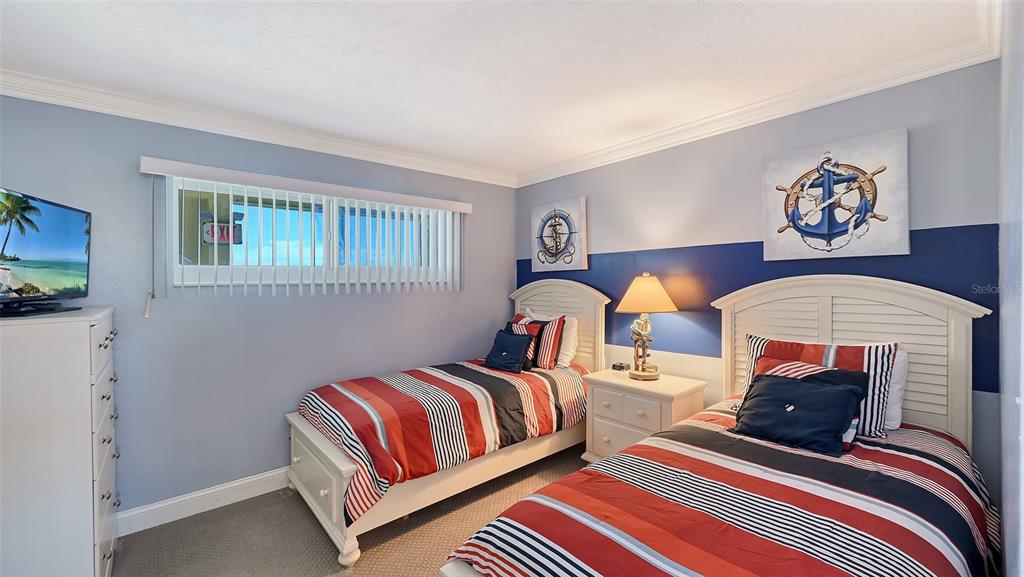 925 Beach Road, Unit 311 Sarasota, FL 34242 - Photo 18 of 53 a bedroom with two beds and painting on the wall