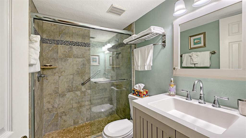 925 Beach Road, Unit 311 Sarasota, FL 34242 - Photo 19 of 53 a bathroom with a sink toilet and shower