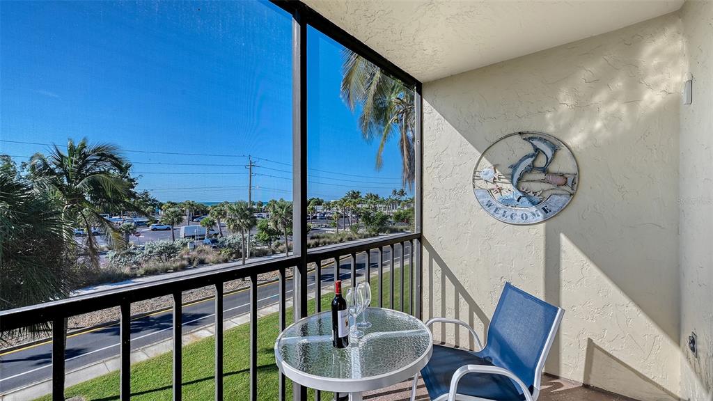 925 Beach Road, Unit 311 Sarasota, FL 34242 - Photo 20 of 53 a view of a chairs and table in the balcony