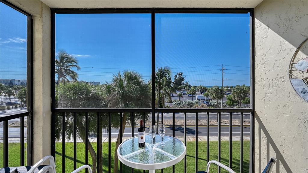 925 Beach Road, Unit 311 Sarasota, FL 34242 - Photo 23 of 53 a view of a balcony with lake view and a potted plant