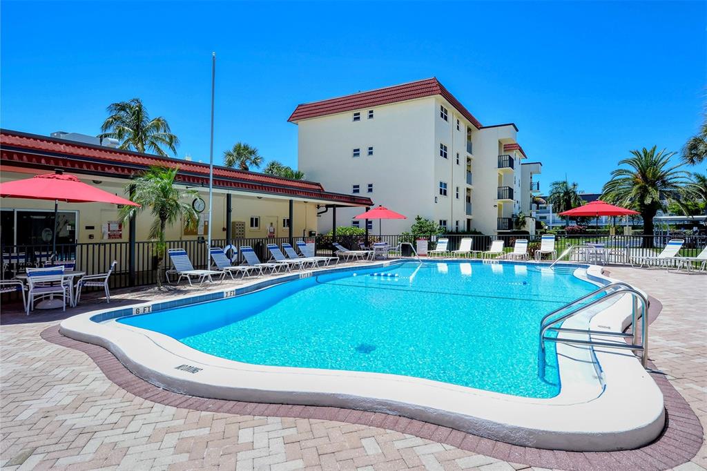925 Beach Road, Unit 311 Sarasota, FL 34242 - Photo 25 of 53 a view of a swimming pool with outdoor seating