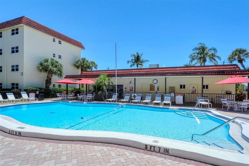 925 Beach Road, Unit 311 Sarasota, FL 34242 - Photo 26 of 53 a view of a chairs and table in the patio