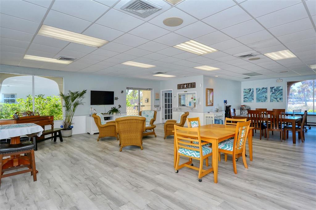925 Beach Road, Unit 311 Sarasota, FL 34242 - Photo 30 of 53 a view of a dining room with furniture window and wooden floor