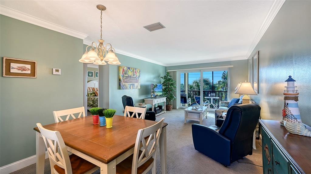 925 Beach Road, Unit 311 Sarasota, FL 34242 - Photo 7 of 53 a view of a dining room with furniture window and outside view
