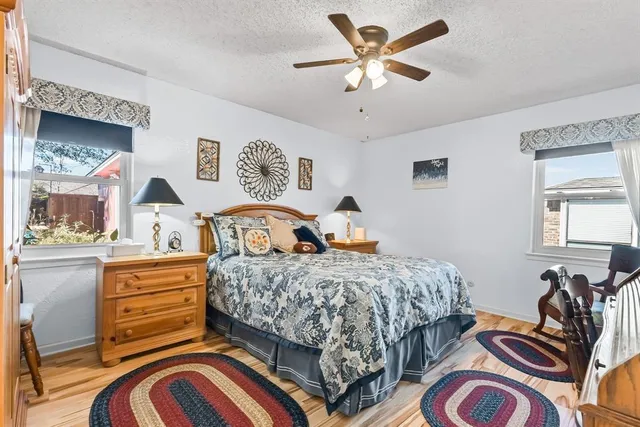 a bedroom with a bed and a chandelier