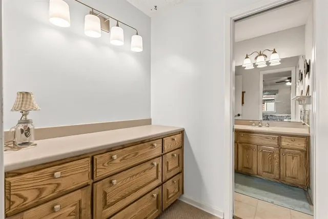 a bathroom with a sink vanity and mirror