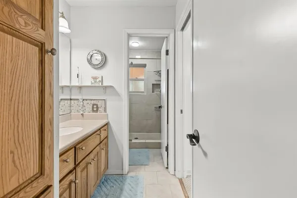 a bathroom with a sink a vanity and a mirror