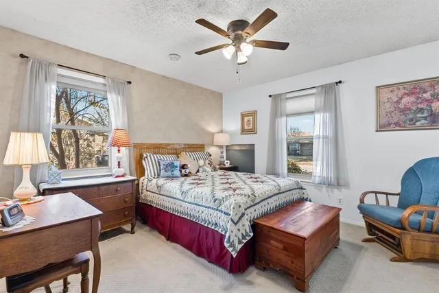 a bedroom with a bed a couch and a window