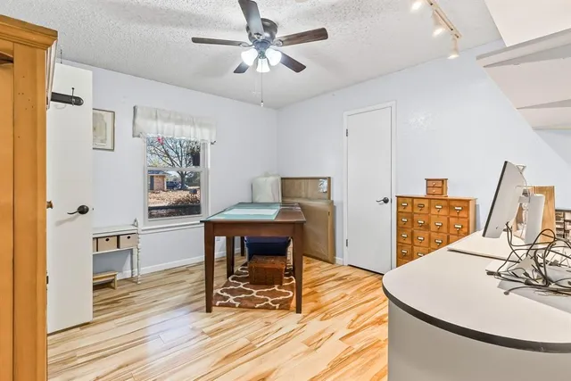 a work room with furniture and wooden floor