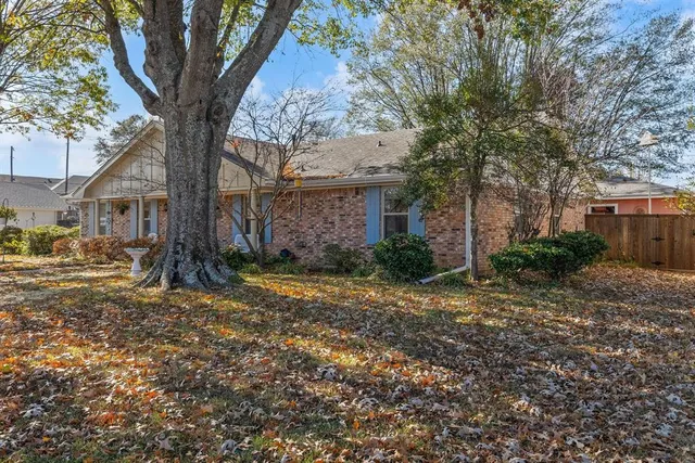 a view of a house with a tree in the background