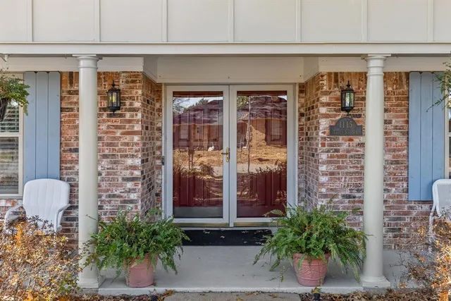a front view of a building with potted plants