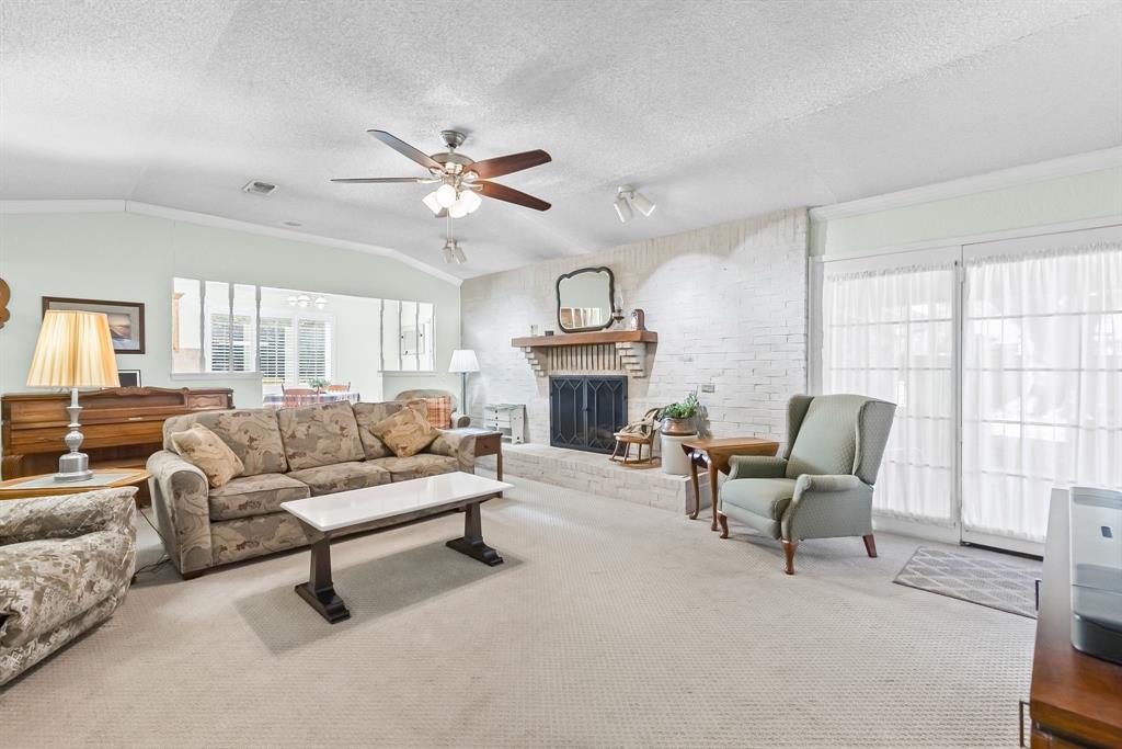 1115 36th Street Northeast Paris, TX 75462 - Photo 5 of 29 a living room with furniture a fireplace and a large window